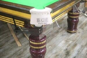 Professional snooker table installation process showing slate leveling and setup