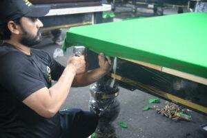 Professional snooker table installation process showing slate leveling and setup