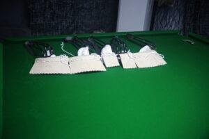 Professional snooker table installation process showing slate leveling and setup