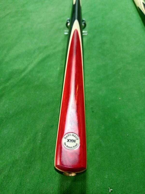 The XYH Handmade Snooker Cue, a premium professional cue stick crafted with precision, is designed for serious players who demand quality and performance. Featuring a 57 inch length, an 18oz balanced weight, and a 9.5mm tip size, this 3 piece snooker cue offers excellent control, spin, and accuracy. Made from high-quality ash wood, with a strong butt design, elegant red butt finish, and ebony splices, it combines both style and durability. The brass joint ensures long-lasting strength, while the smooth finishing provides a comfortable grip for consistent play. Whether you are looking for a professional snooker cue, handmade cue stick, billiard cue stick, or personal snooker cue, the XYH model is one of the best snooker cues in Pakistan, perfect for home, clubs, or tournaments.